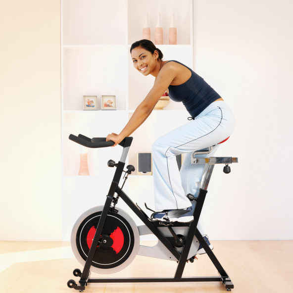 Die richtigen Geräte unterstützen das Abnehmen Zuhause Frau auf dem Heimtrainer